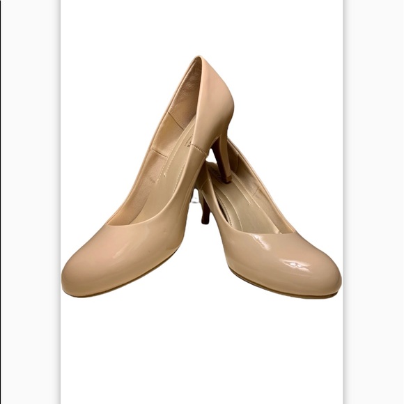 Nude patent pumps with approx 2 1/2 in heel. Almond shape toe